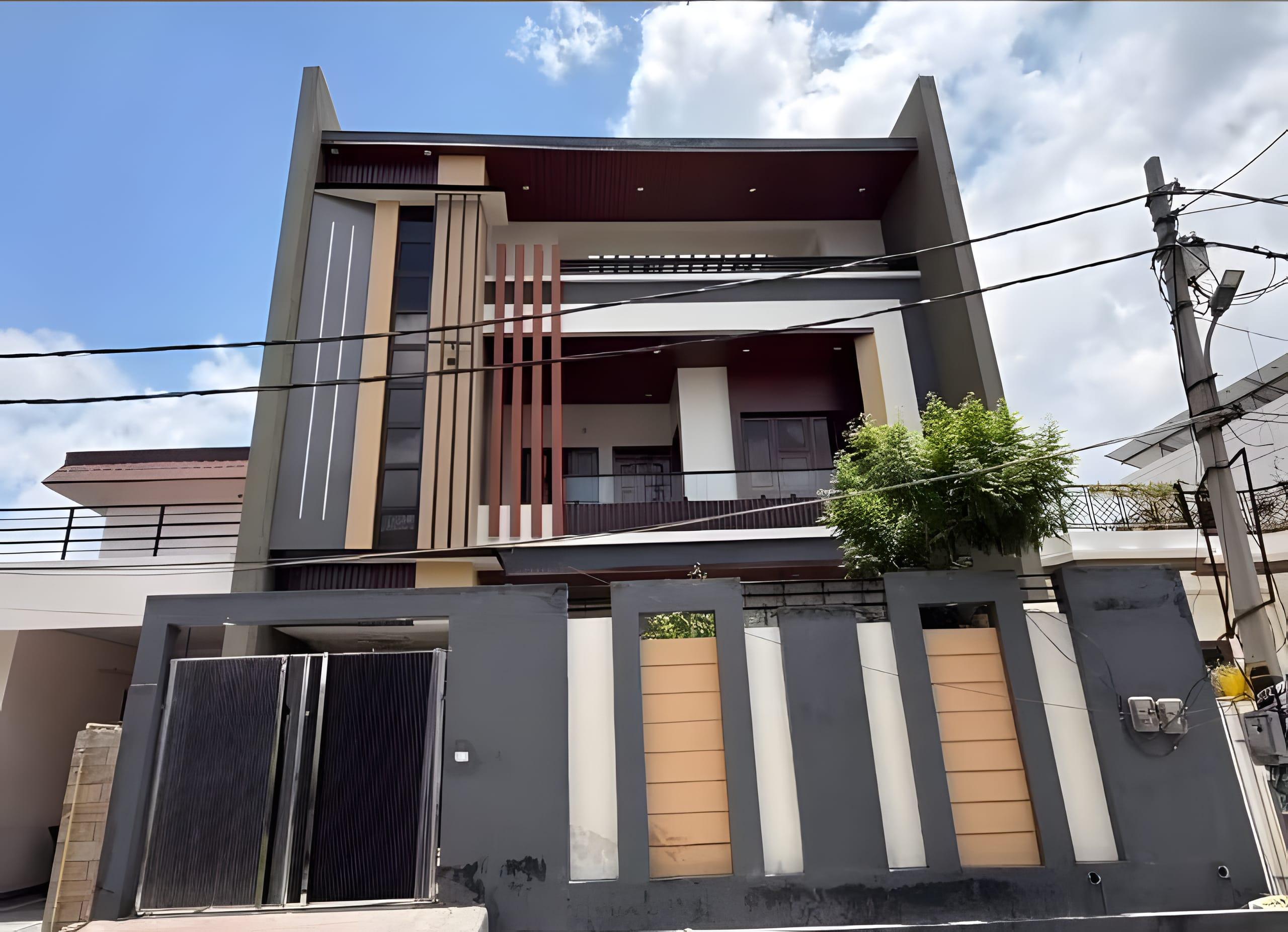 The same house completed, front elevation with maroon vertical fins and a boundary gate